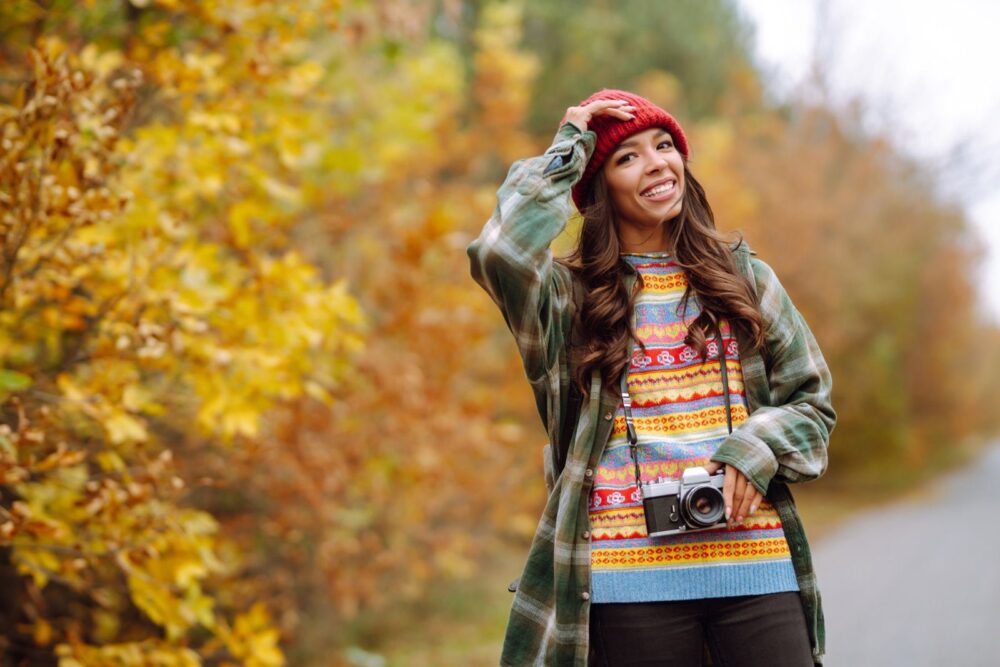 Smuk ung kvinde bliver fotograferet med retro kamera. Afslapning, hvile, rejse, livsstil
